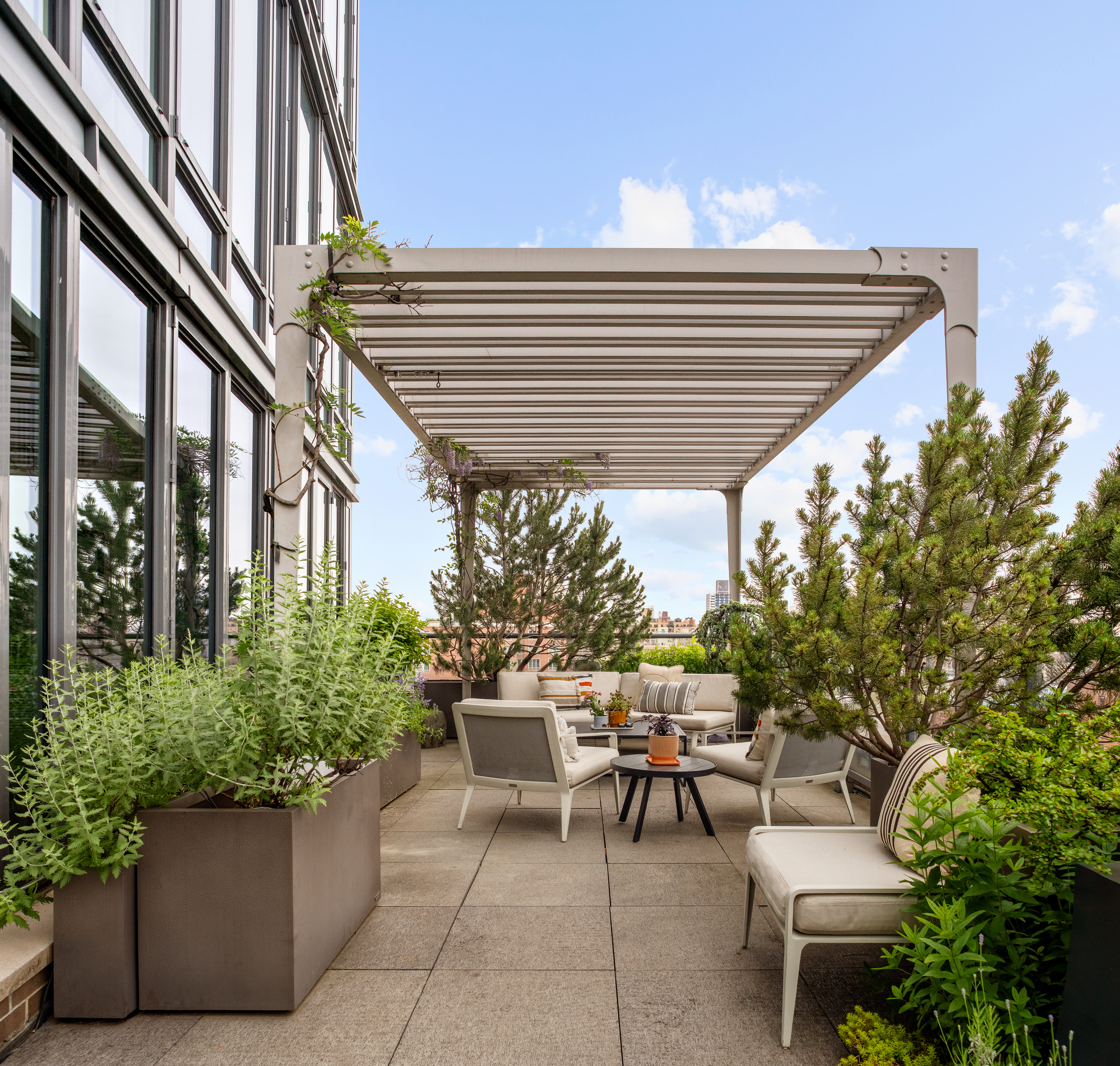 230 West 78th Street, Unit PH19 Manhattan, NY 10024 - Photo 4 of 17 a patio with table and chairs and potted plants