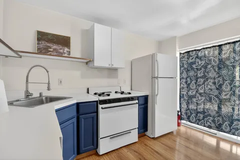 a kitchen with stainless steel appliances granite countertop a refrigerator and a sink