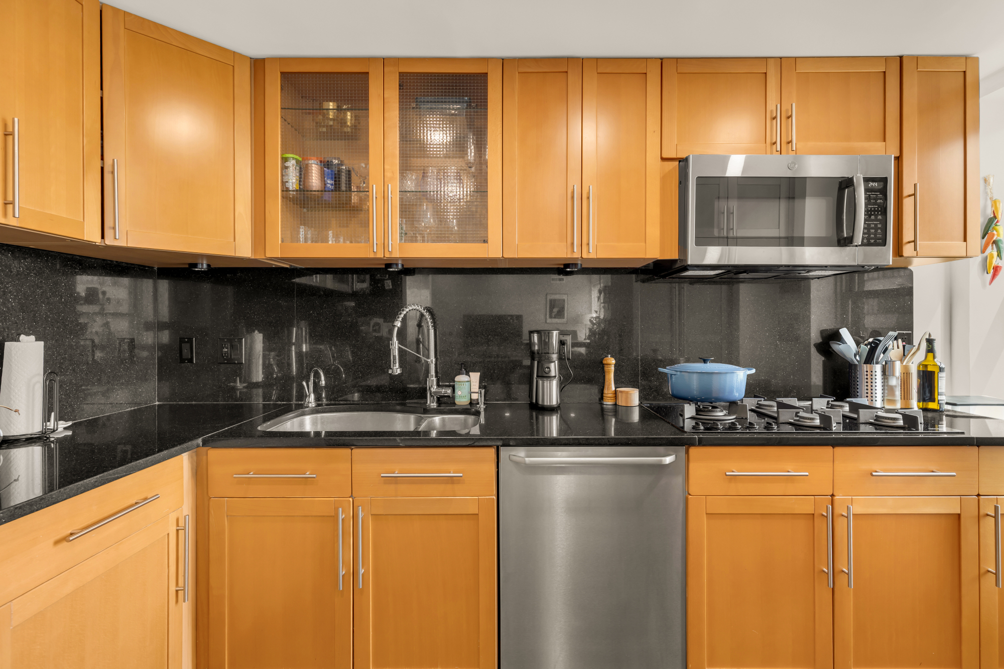 2127 California Street Northwest, Unit 505 Washington, DC 20008 - Photo 19 of 40 a kitchen with stainless steel appliances granite countertop a sink and cabinets