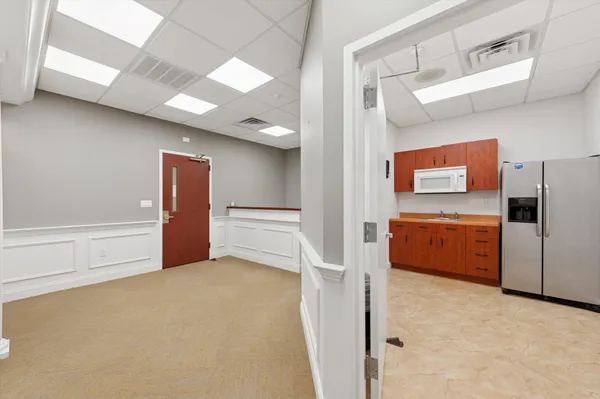 a view of kitchen with refrigerator and window