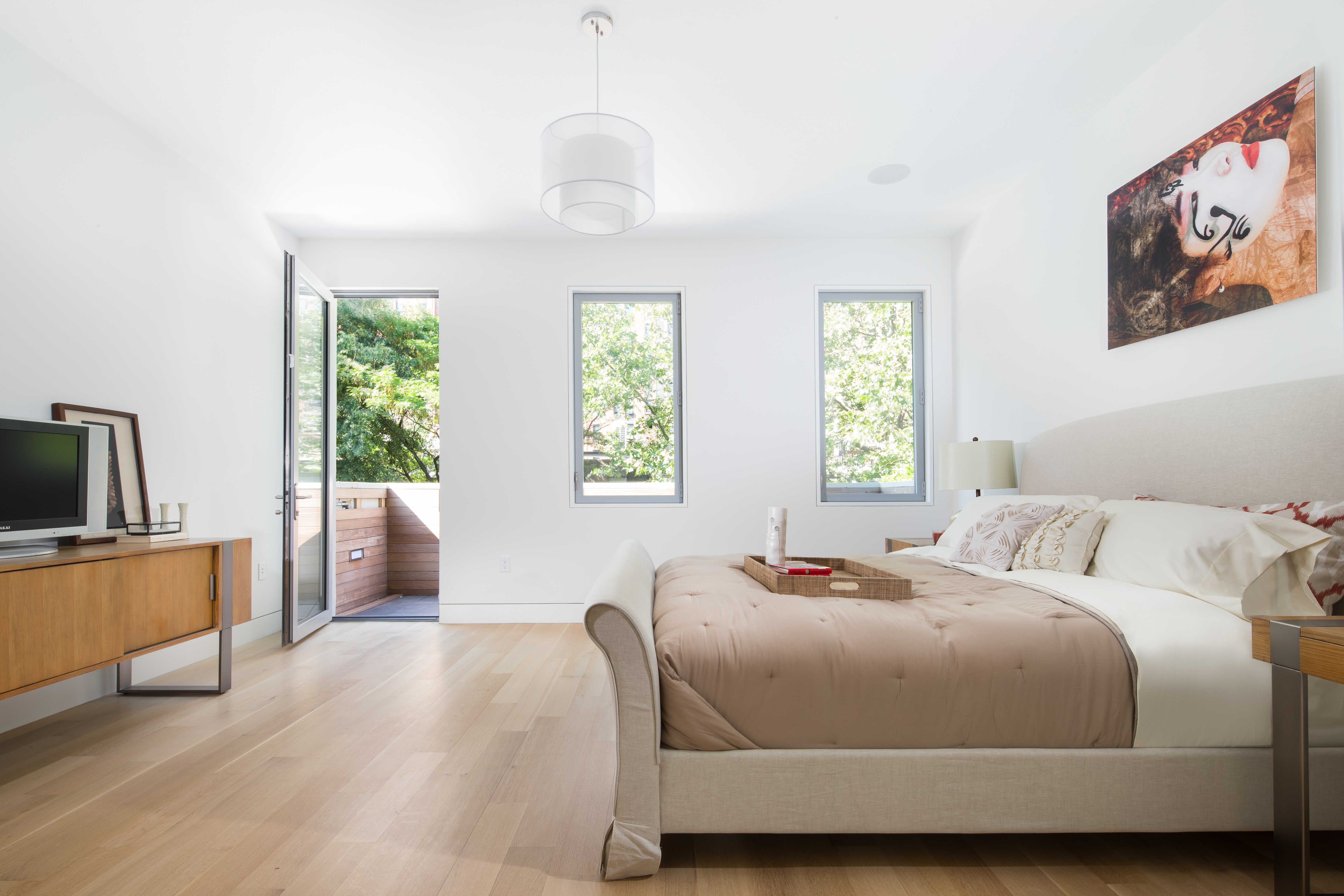 450 West 25th Street Manhattan, NY 10001 - Photo 11 of 16 a bedroom with a bed and a flat screen tv