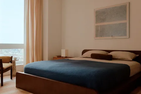 a bedroom with two beds and a window