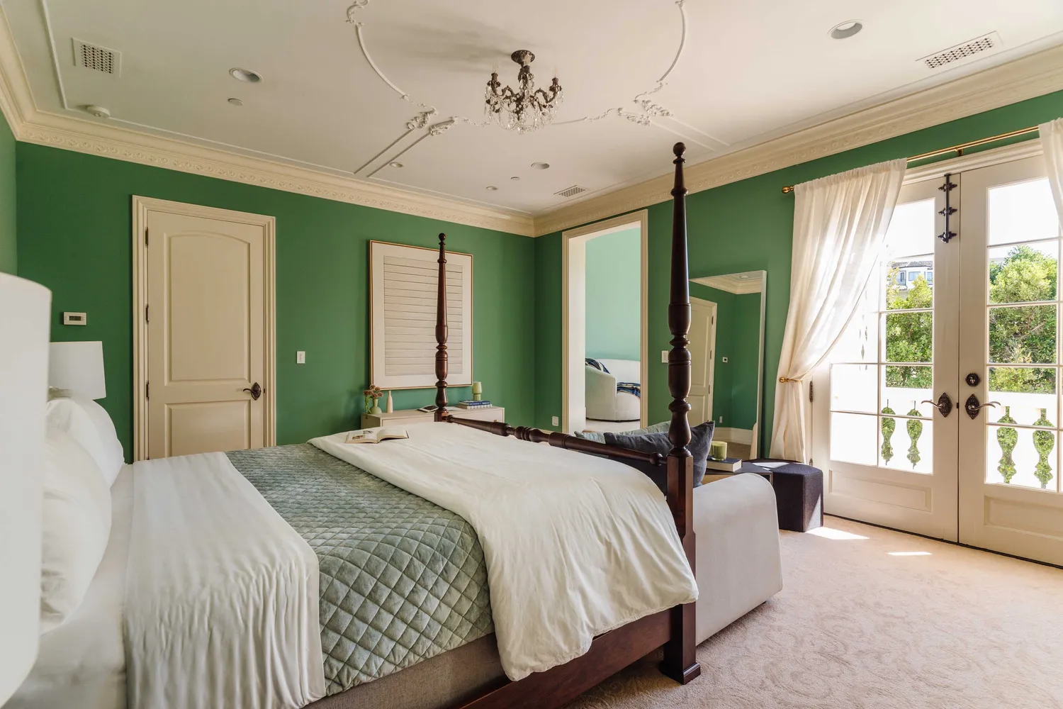 a spacious bedroom with a balcony a bed and a large window