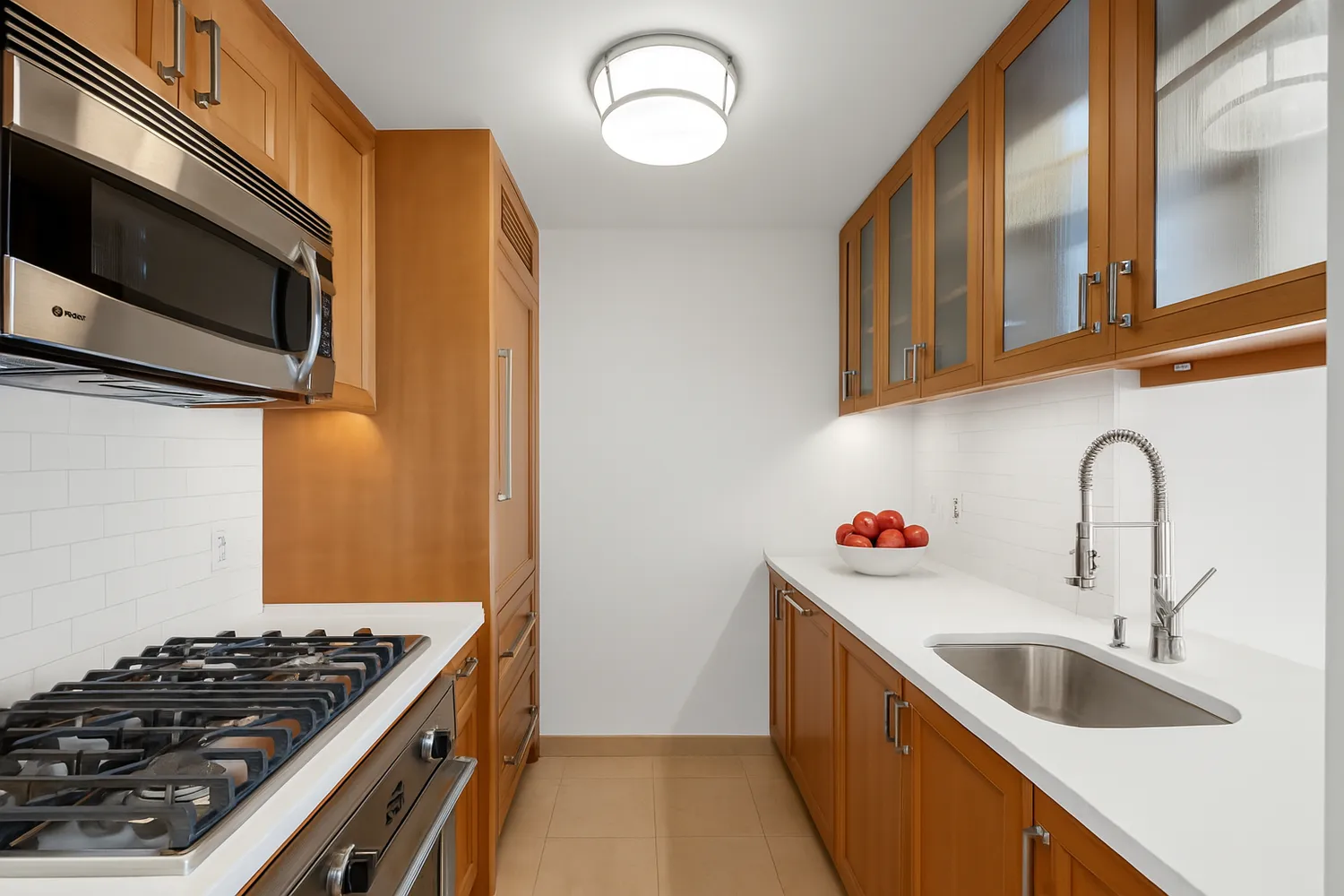 a kitchen with stainless steel appliances granite countertop a sink and a stove