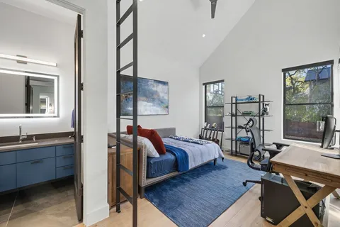 a bedroom with two beds and a window