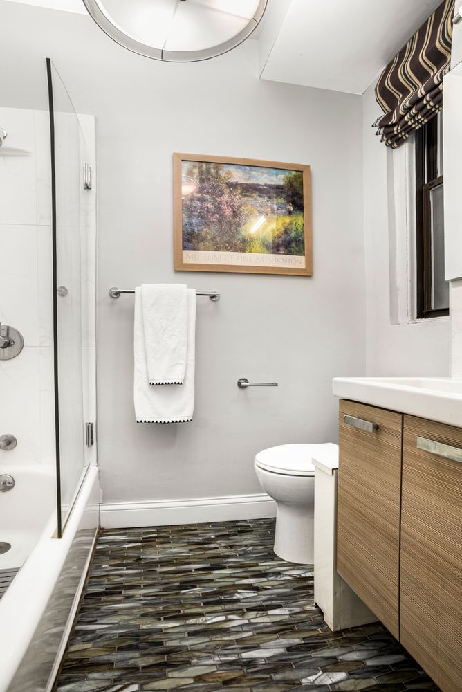 114 West 70th Street, Unit 3D Manhattan, NY 10023 - Photo 5 of 9 a bathroom with a toilet and a shower