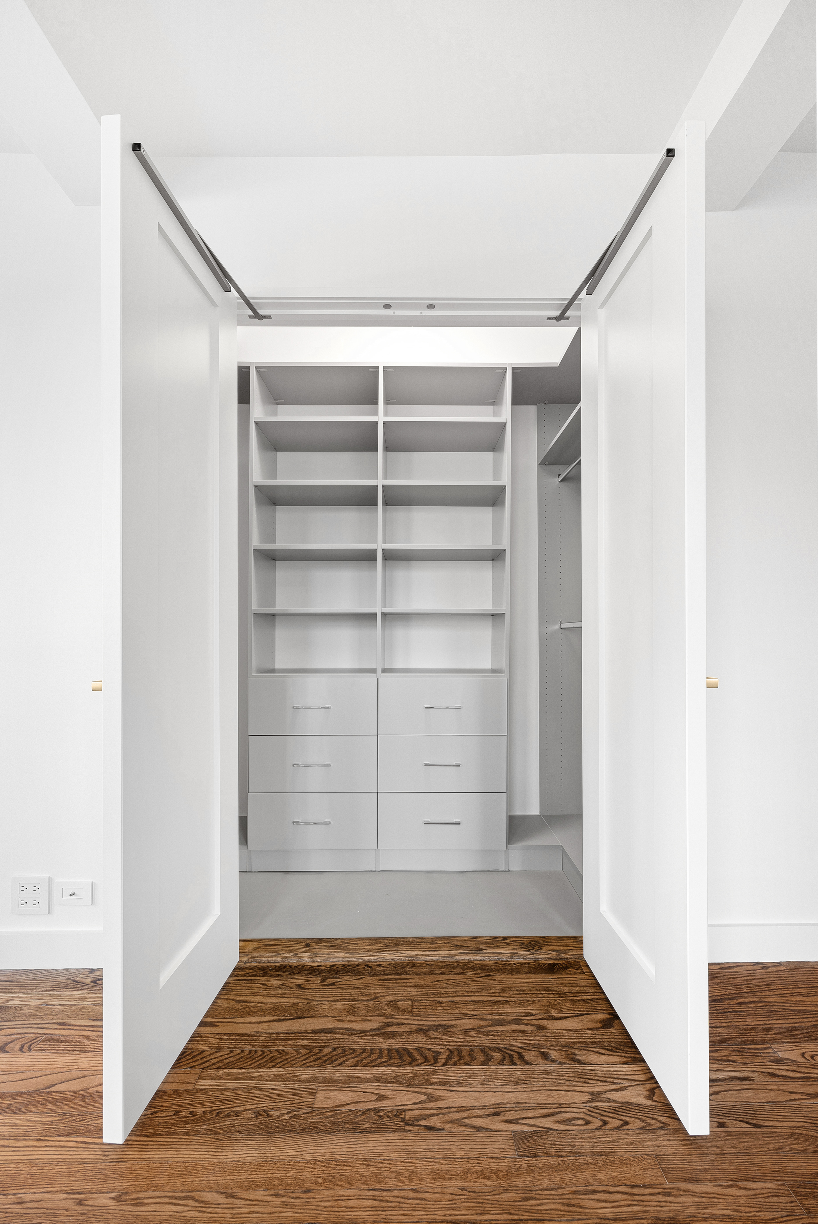 410 West 24th Street, Unit 8F Manhattan, NY 10011 - Photo 10 of 16 a view of an empty walk in closet with empty racks