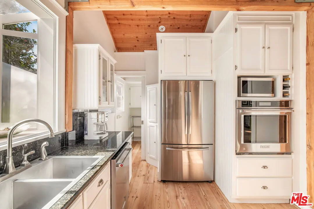 a kitchen with stainless steel appliances a refrigerator sink and cabinets