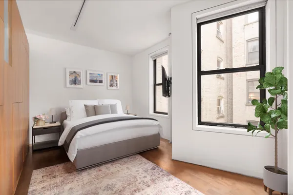 a spacious bedroom with a bed and a window