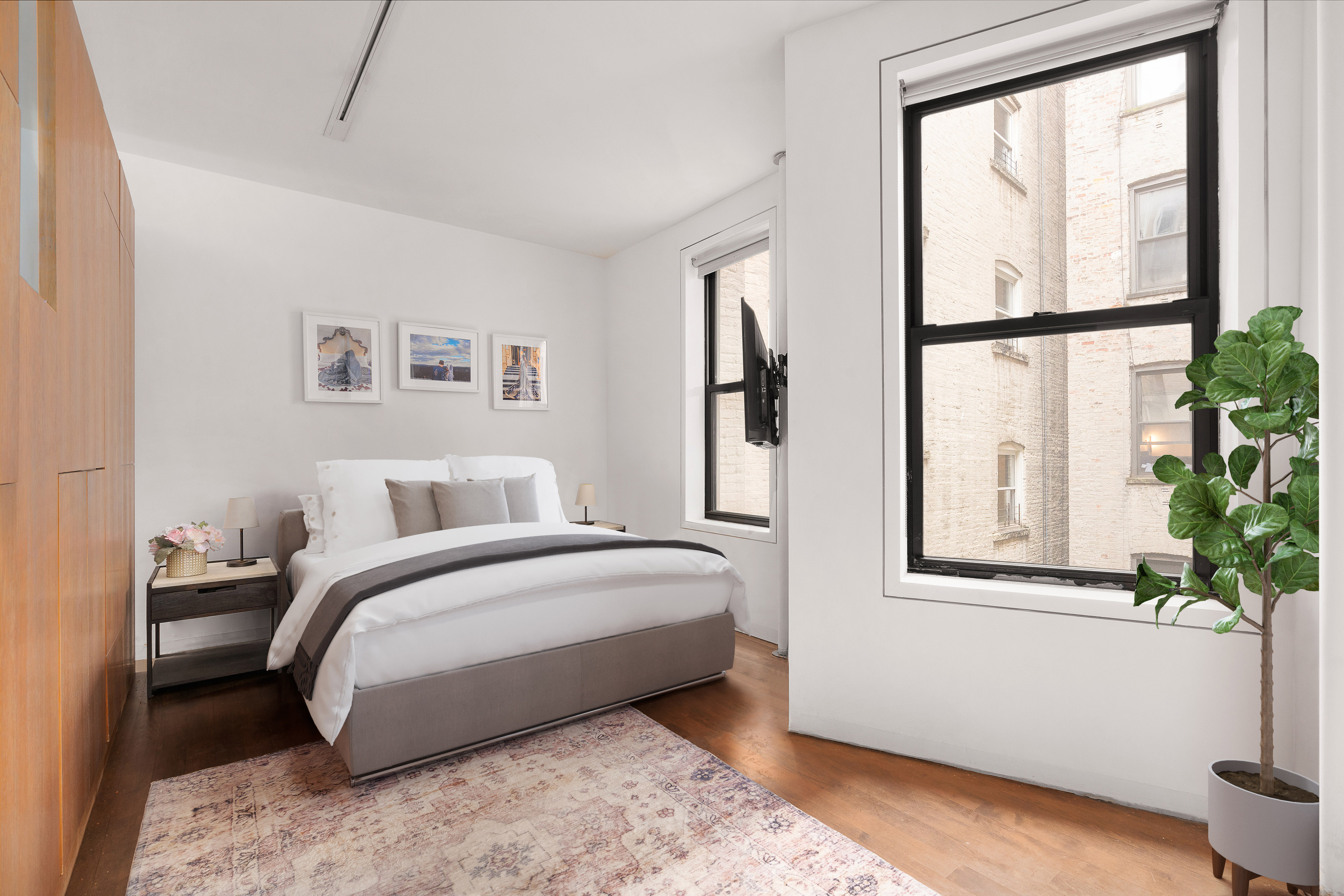 340 West 19th Street, Unit 14 Manhattan, NY 10011 - Photo 8 of 12 a spacious bedroom with a bed and a window