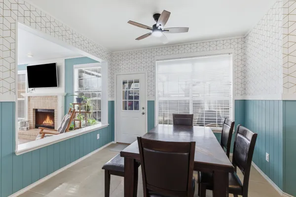 a dining room with furniture a fireplace and a flat screen tv