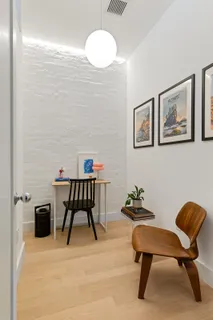 a work room with furniture and a wooden floor