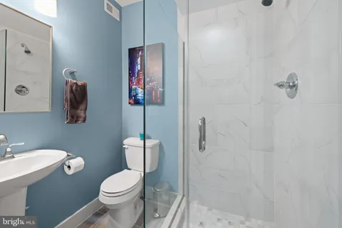 a white toilet sitting next to a bathroom sink