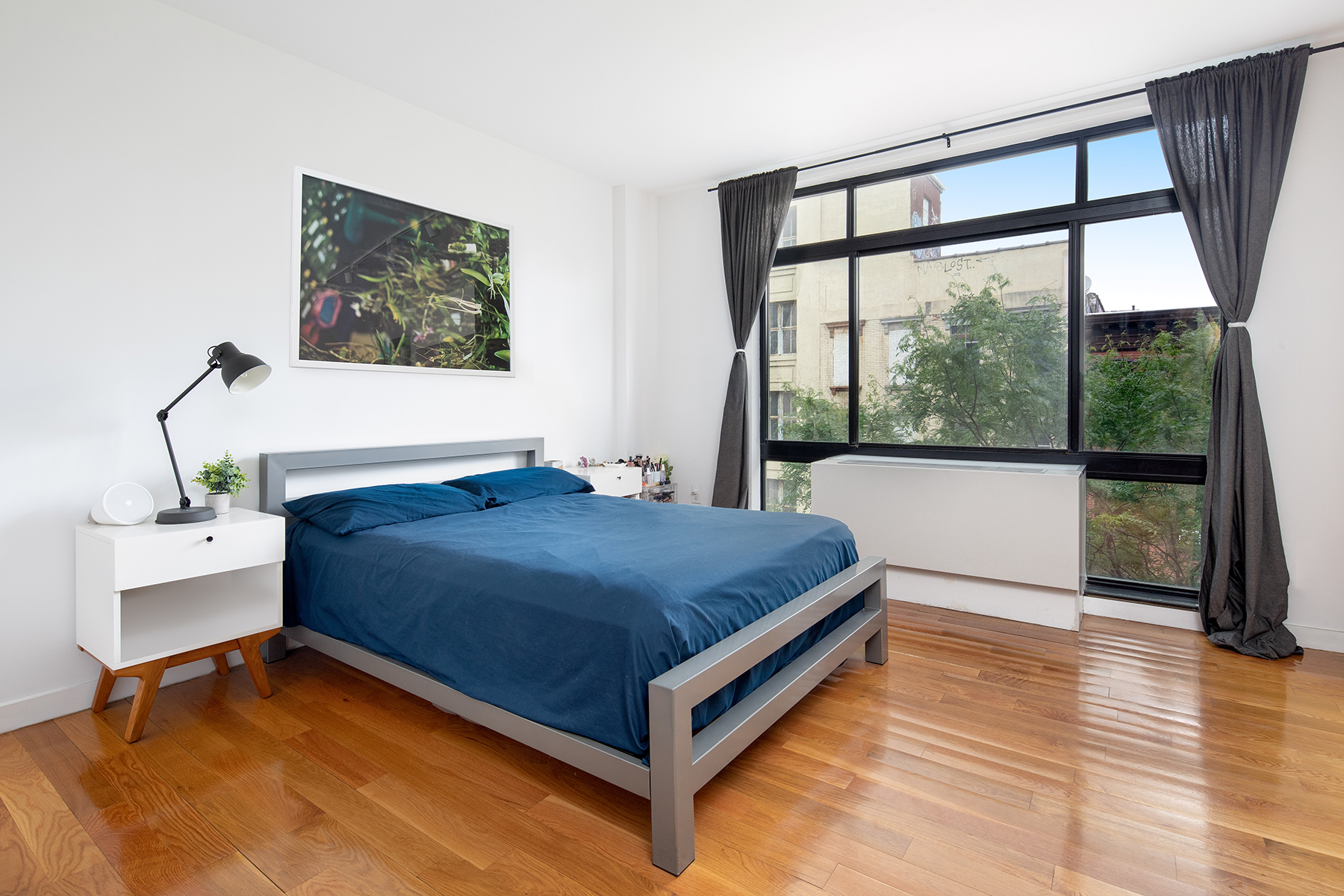 14 Hope Street, Unit 4D Brooklyn, NY 11211 - Photo 4 of 7 a bed sitting in a bedroom next to a window
