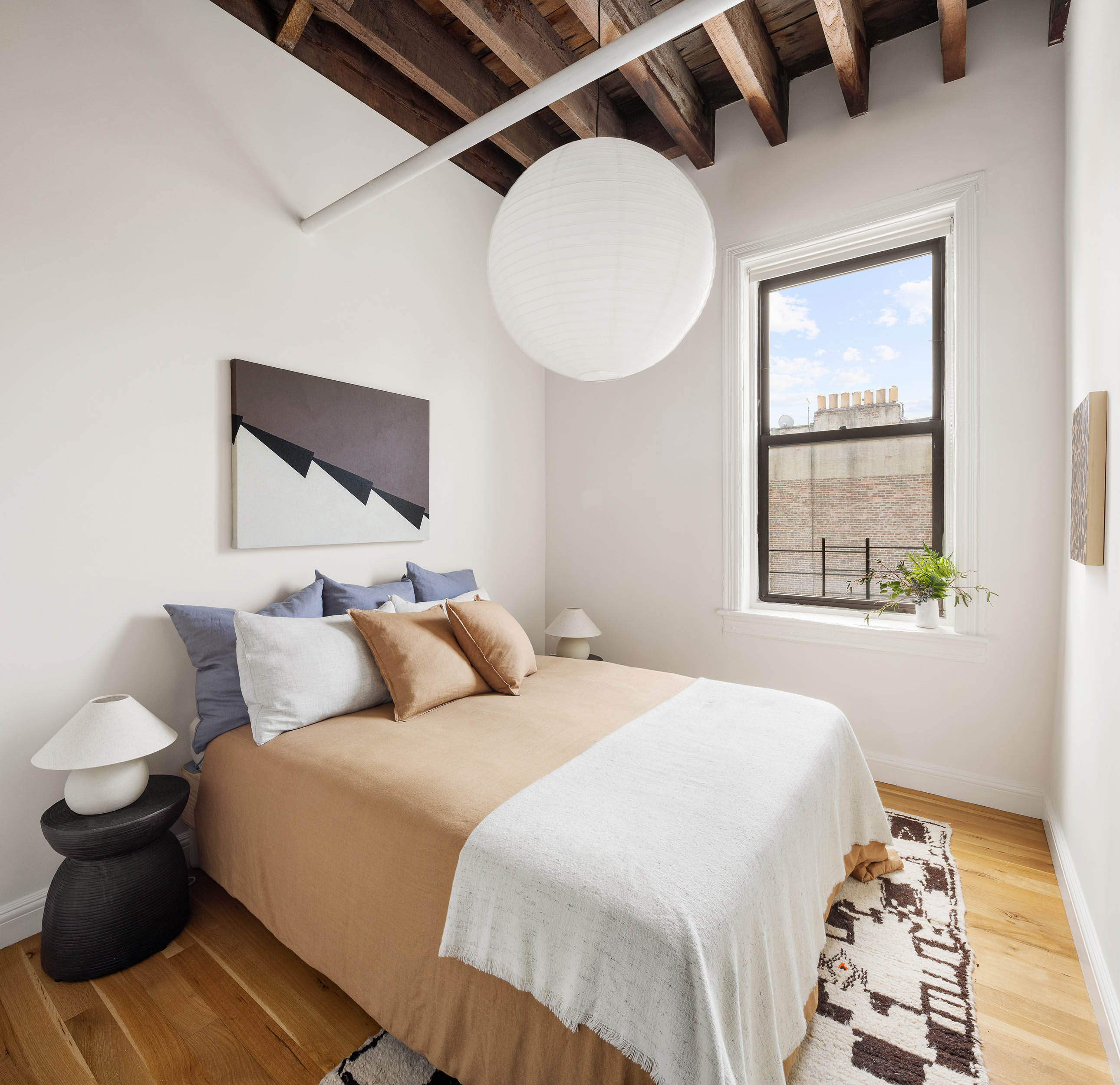 84 Forsyth Street, Unit 5R Manhattan, NY 10002 - Photo 10 of 14 a bedroom with a bed and wooden floor