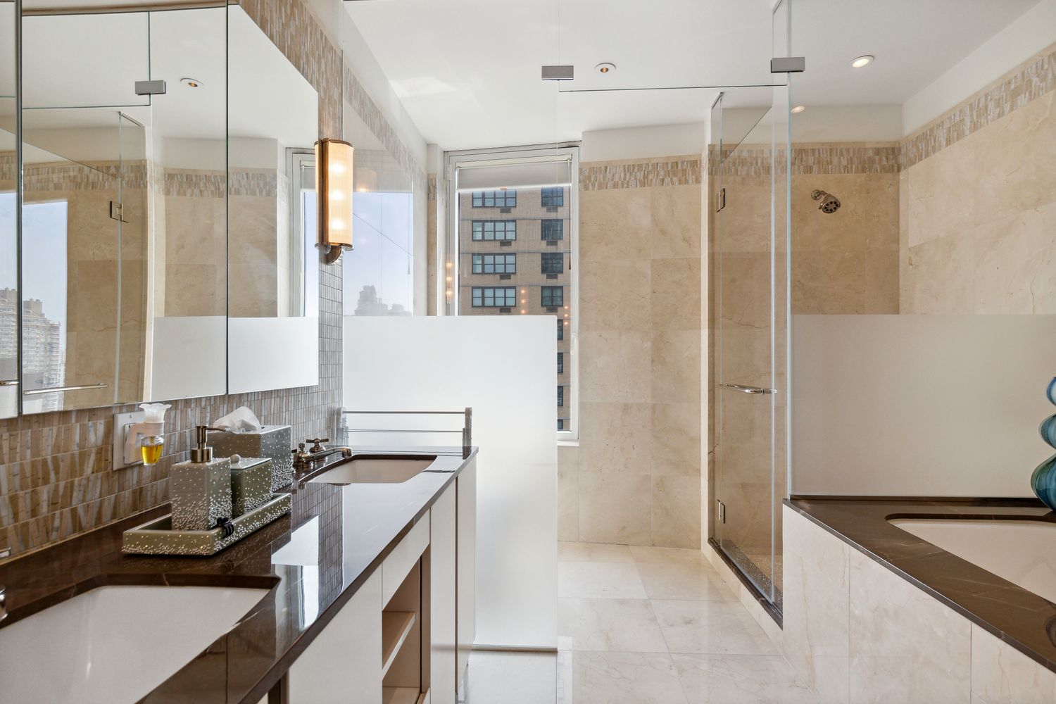 255 East 74th Street, Unit 20C Manhattan, NY 10021 - Photo 8 of 16 a bathroom with a granite countertop sink a mirror and a shower