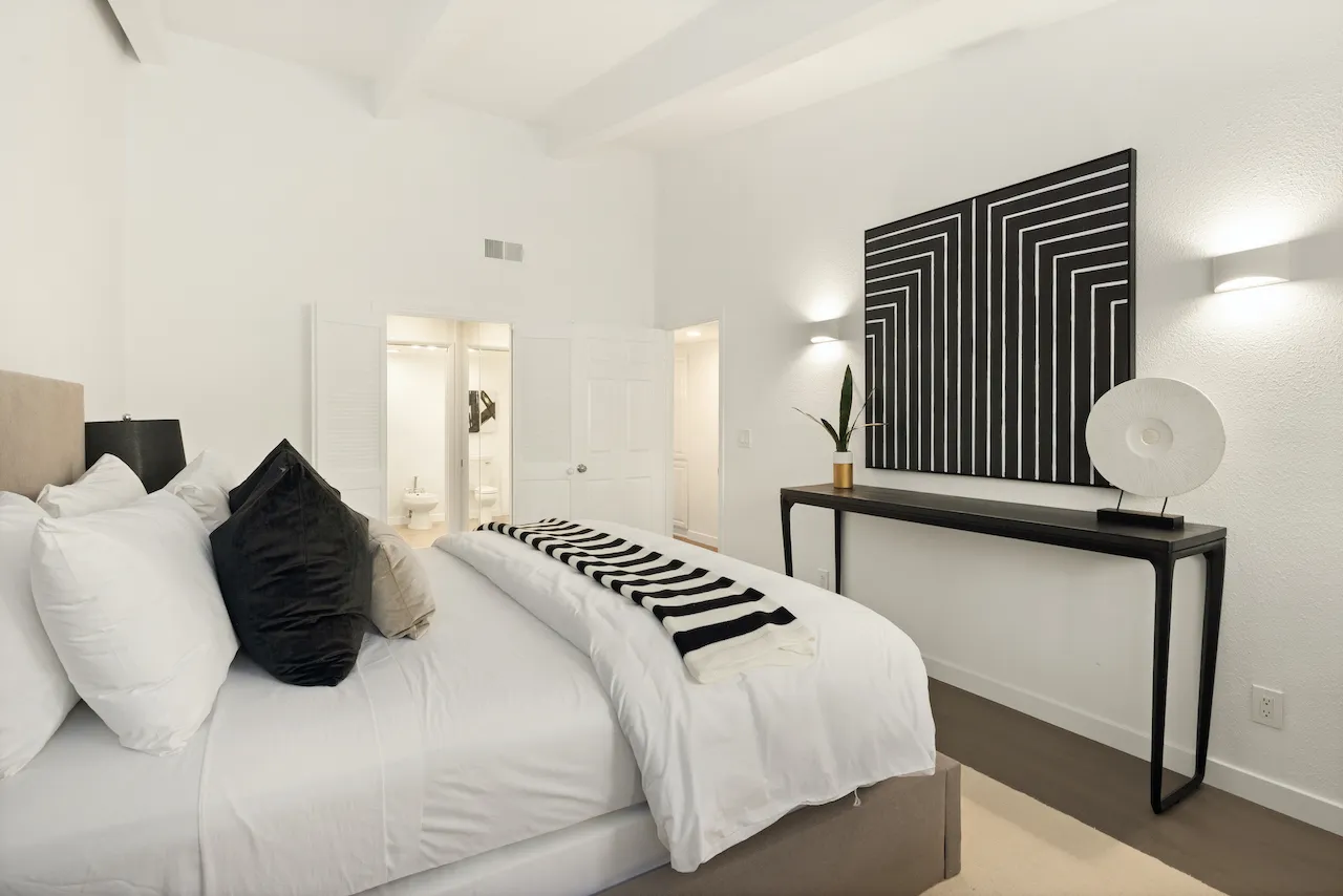 a bedroom with a bed and window