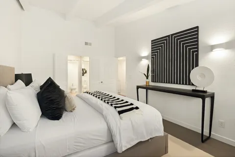 a bedroom with a bed and window