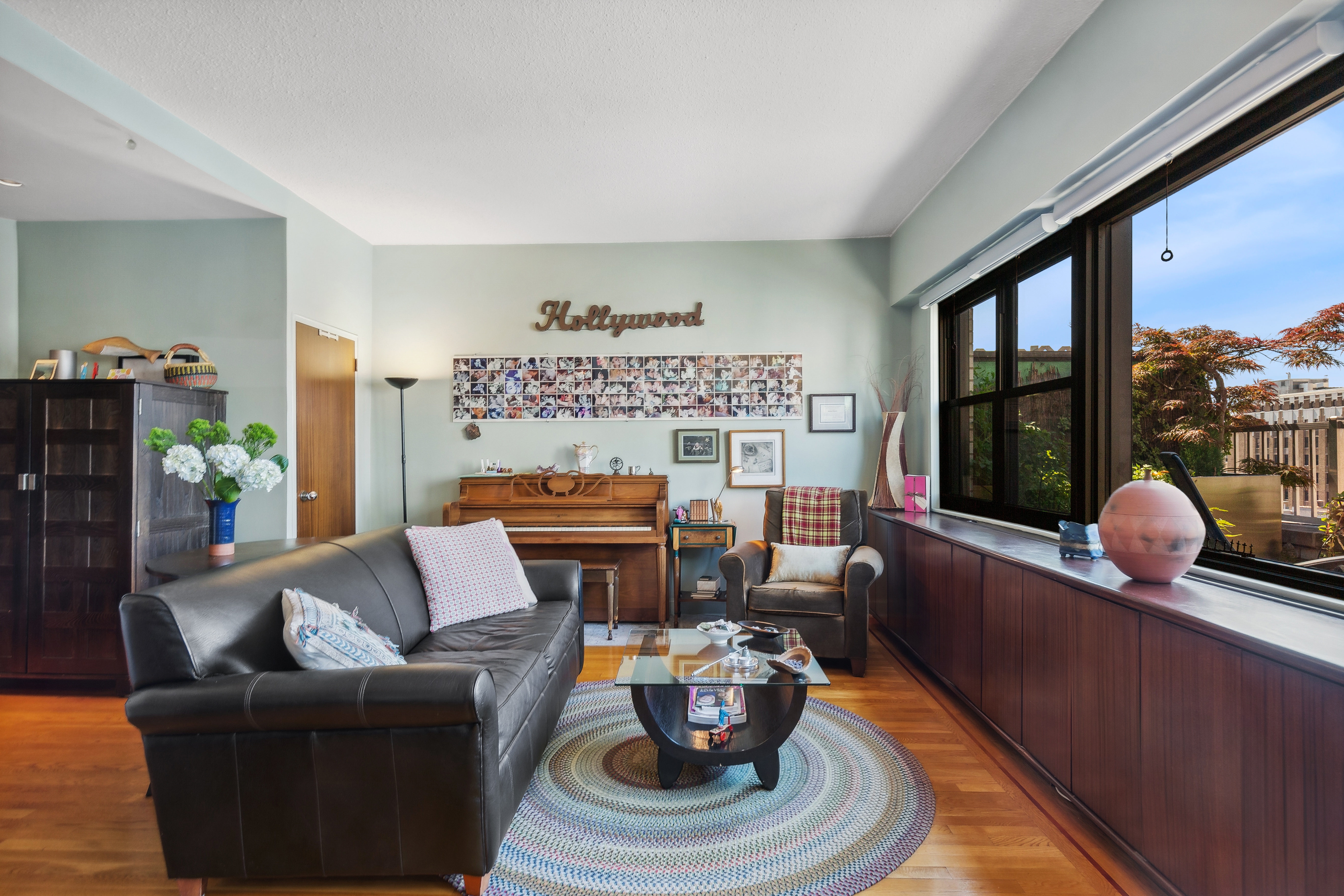 210 East 15th Street, Unit PHD Manhattan, NY 10003 - Photo 4 of 12 a living room with furniture and a large window