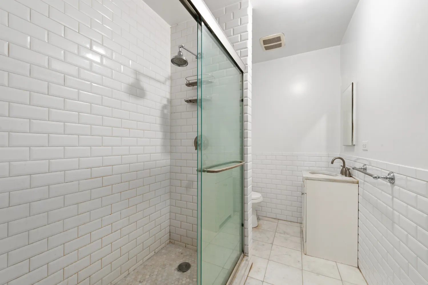 a bathroom with a shower and a sink