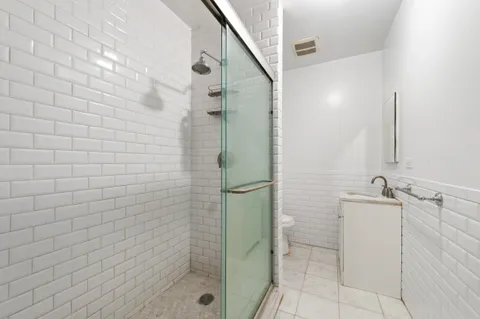 a bathroom with a shower and a sink
