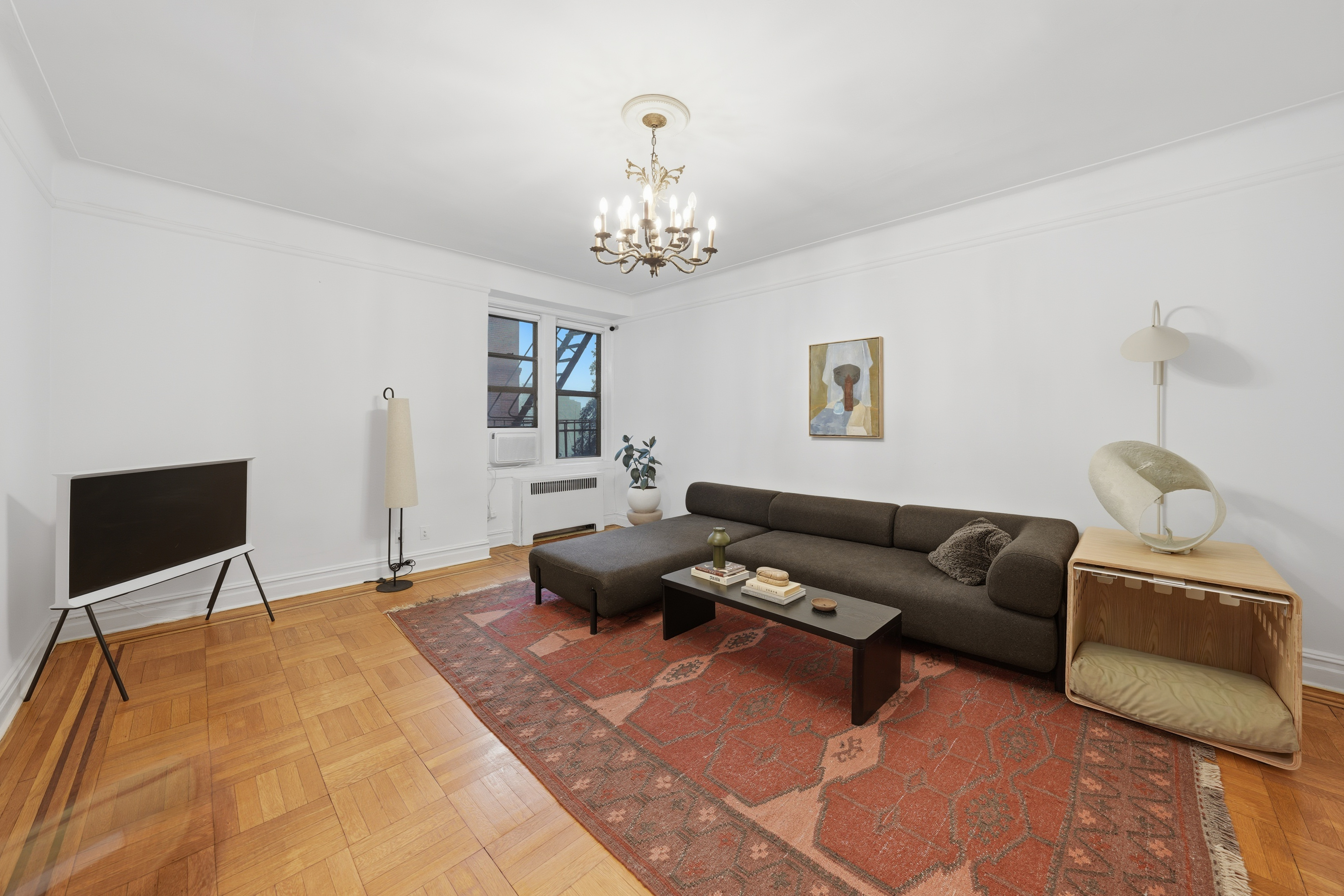 80 Avenue P, Unit D14 Brooklyn, NY 11204 - Photo 1 of 19 a living room with furniture and a chandelier
