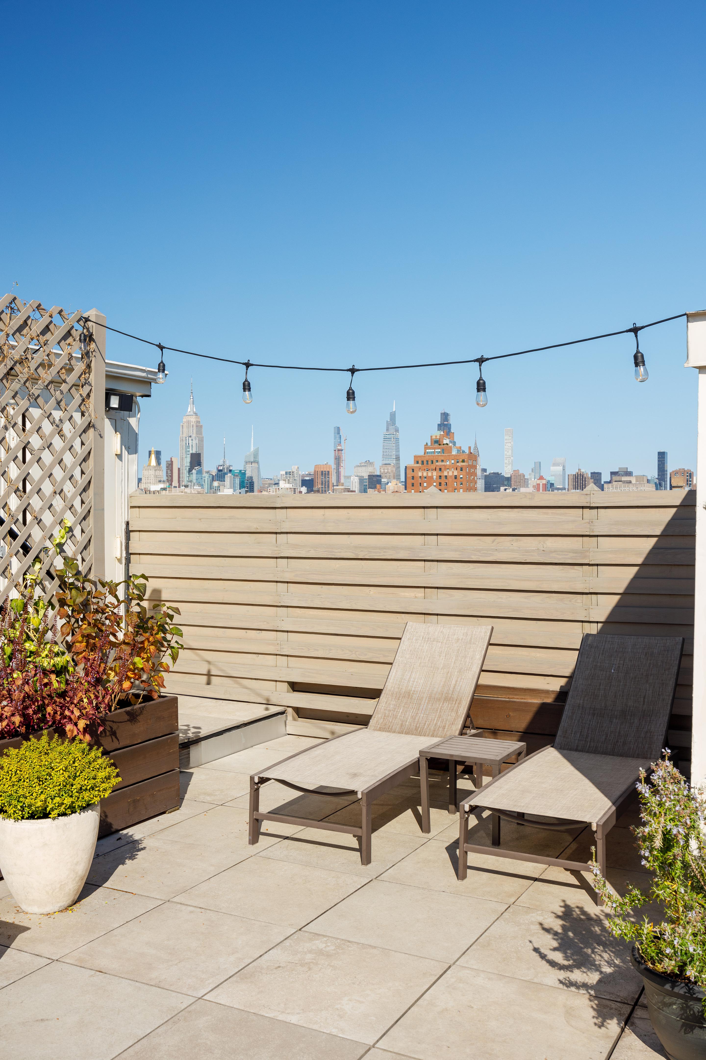 300 East 4th Street, Unit 2A Manhattan, NY 10009 - Photo 13 of 15 a view of a terrace with chairs and potted plants