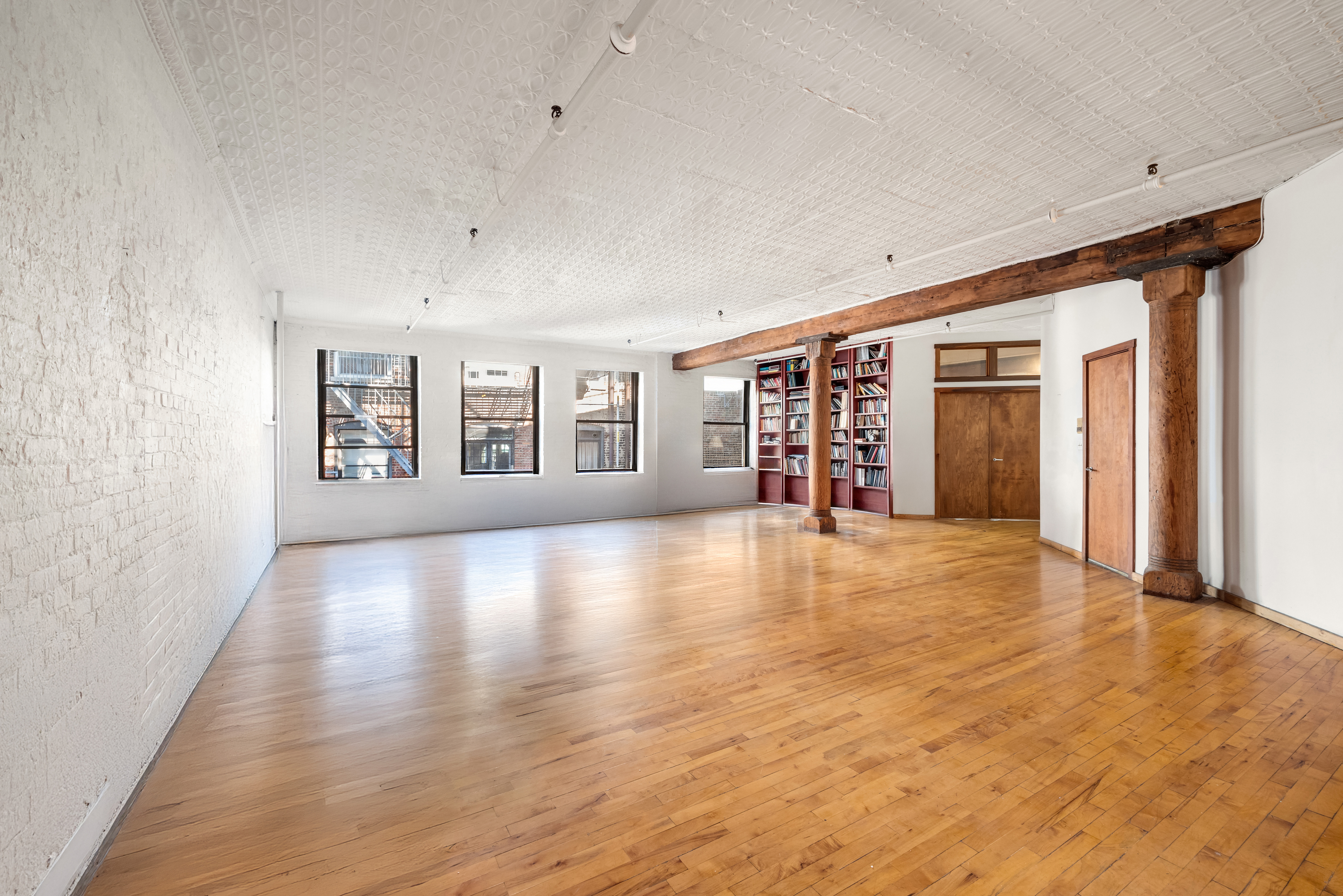 27 Bleecker Street, Unit 6B Manhattan, NY 10012 - Photo 1 of 7 an empty room with wooden floor and windows
