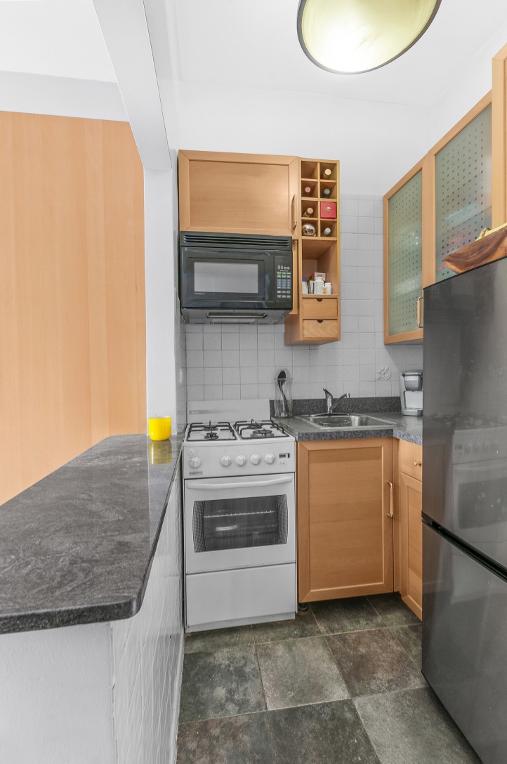 421 West 57th Street, Unit 3C Manhattan, NY 10019 - Photo 3 of 18 a kitchen with stainless steel appliances granite countertop a stove a sink and a refrigerator