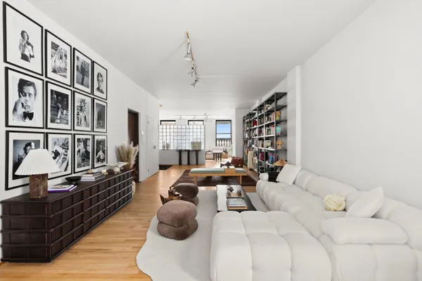 a bedroom with furniture or couch and a wooden floor