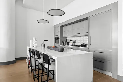 a kitchen with stainless steel appliances a sink a stove and a refrigerator
