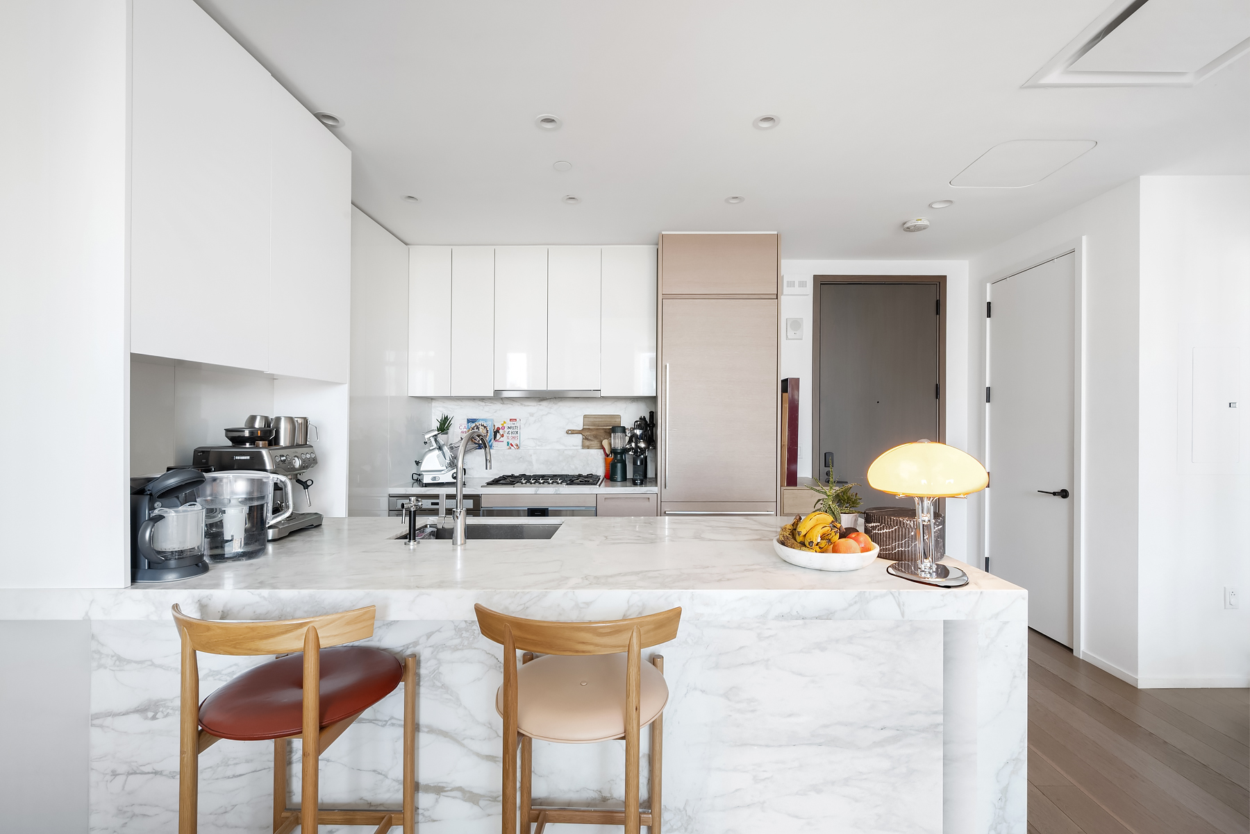30 Riverside Boulevard, Unit 32E Manhattan, NY 10069 - Photo 3 of 19 a kitchen with stainless steel appliances granite countertop a table and chairs