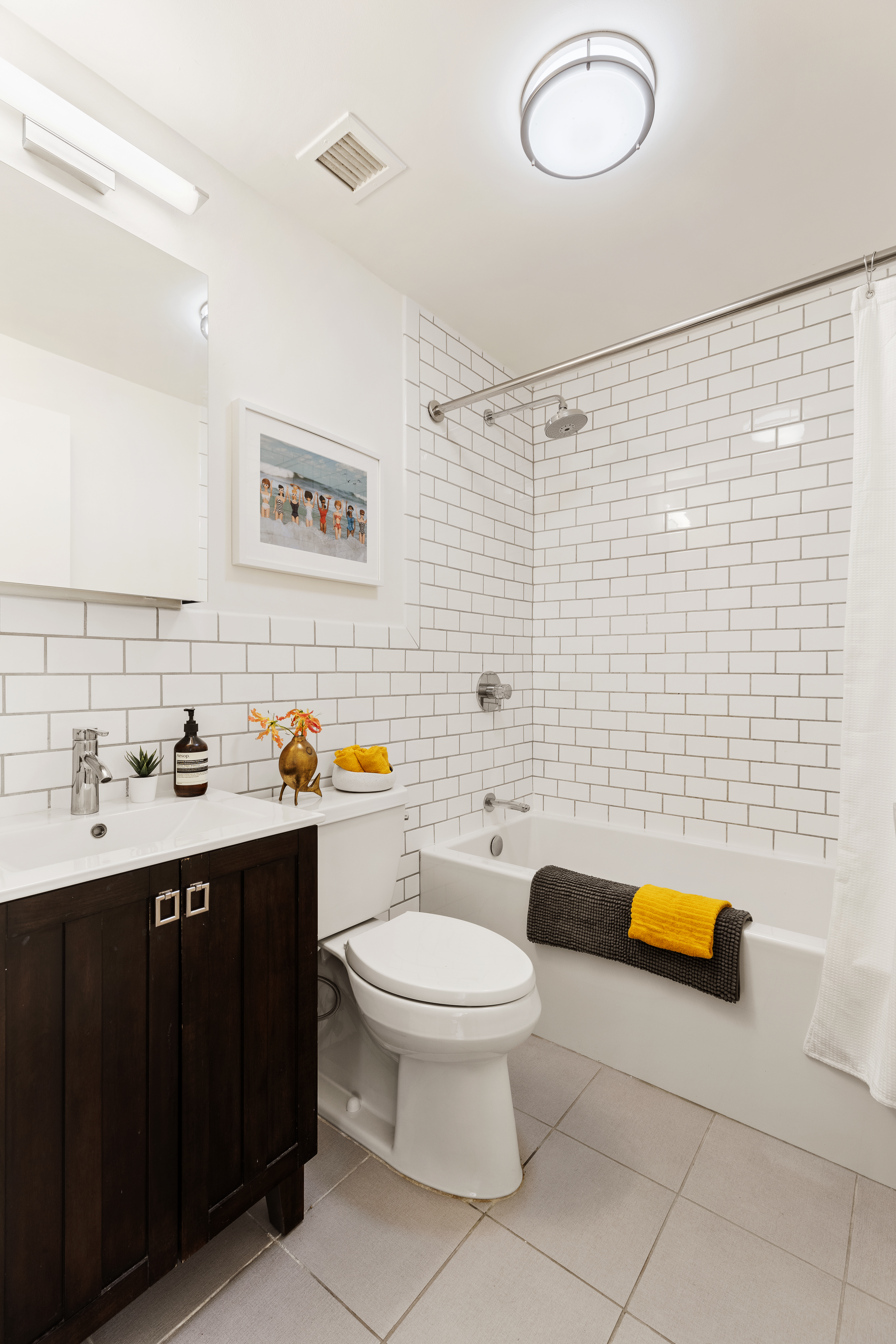 167 Perry Street, Unit 4K Manhattan, NY 10014 - Photo 7 of 11 a bathroom with a sink toilet and tub