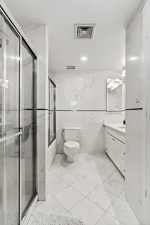 a bathroom with a toilet sink and a mirror