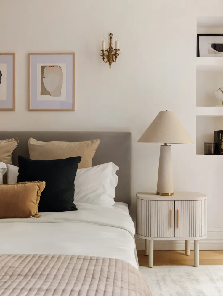 a bedroom with bed and a night stand