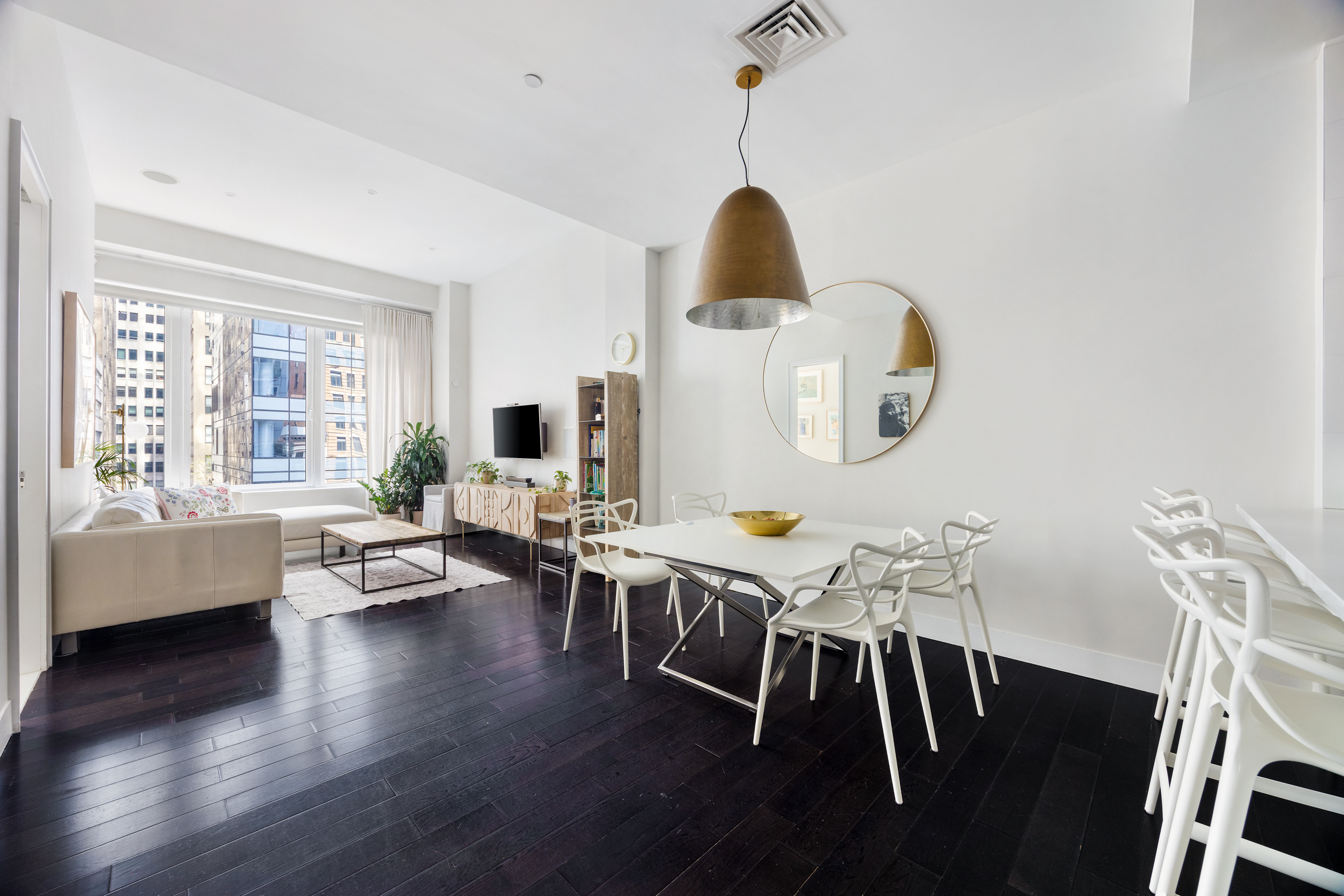 111 Fulton Street, Unit 824 Manhattan, NY 10038 - Photo 3 of 35 a view of a dining room with furniture a potted plant and wooden floor