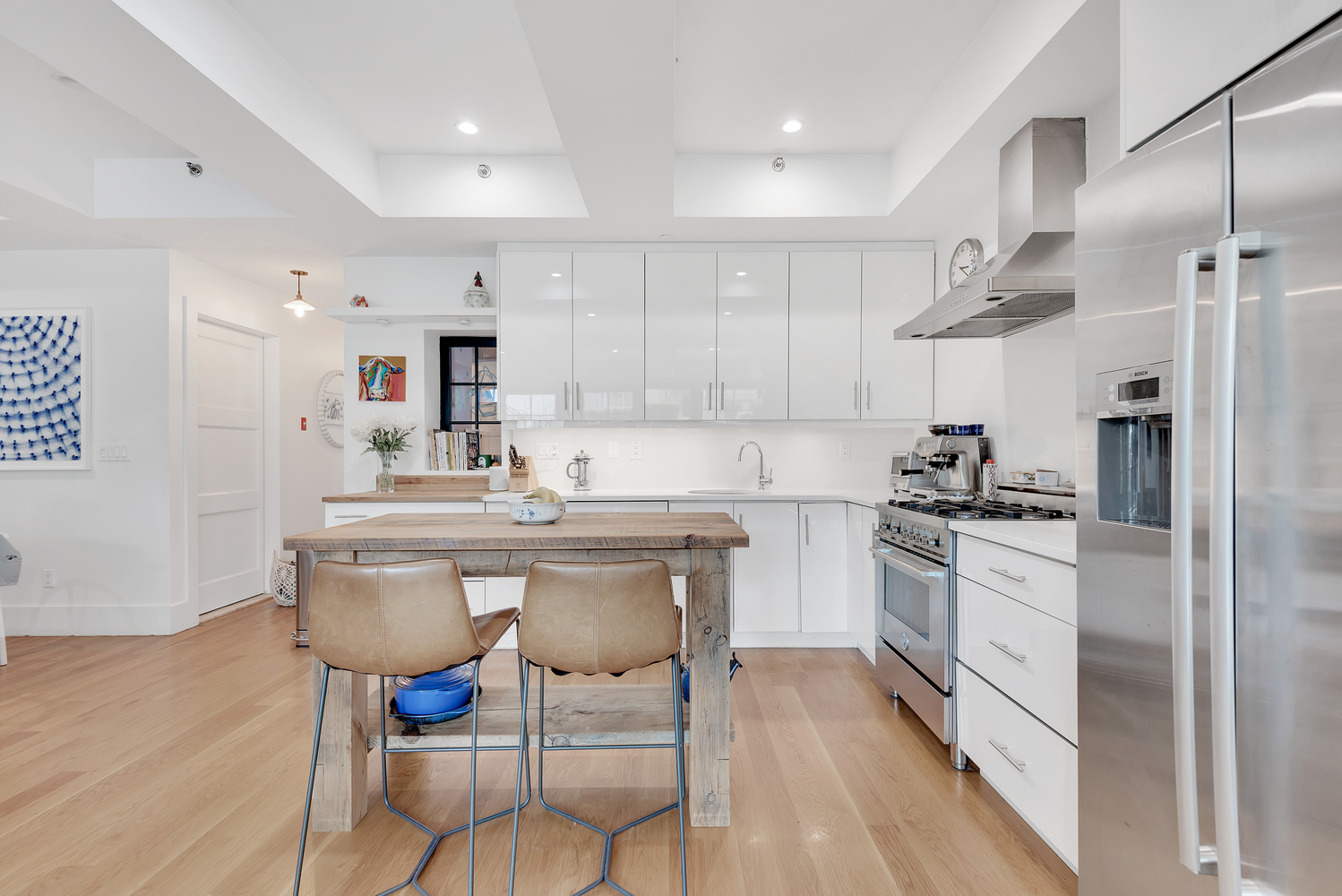 49 Summit Street, Unit 1C Brooklyn, NY 11231 - Photo 4 of 10 a kitchen with stainless steel appliances a sink a stove a refrigerator cabinets and a dining table