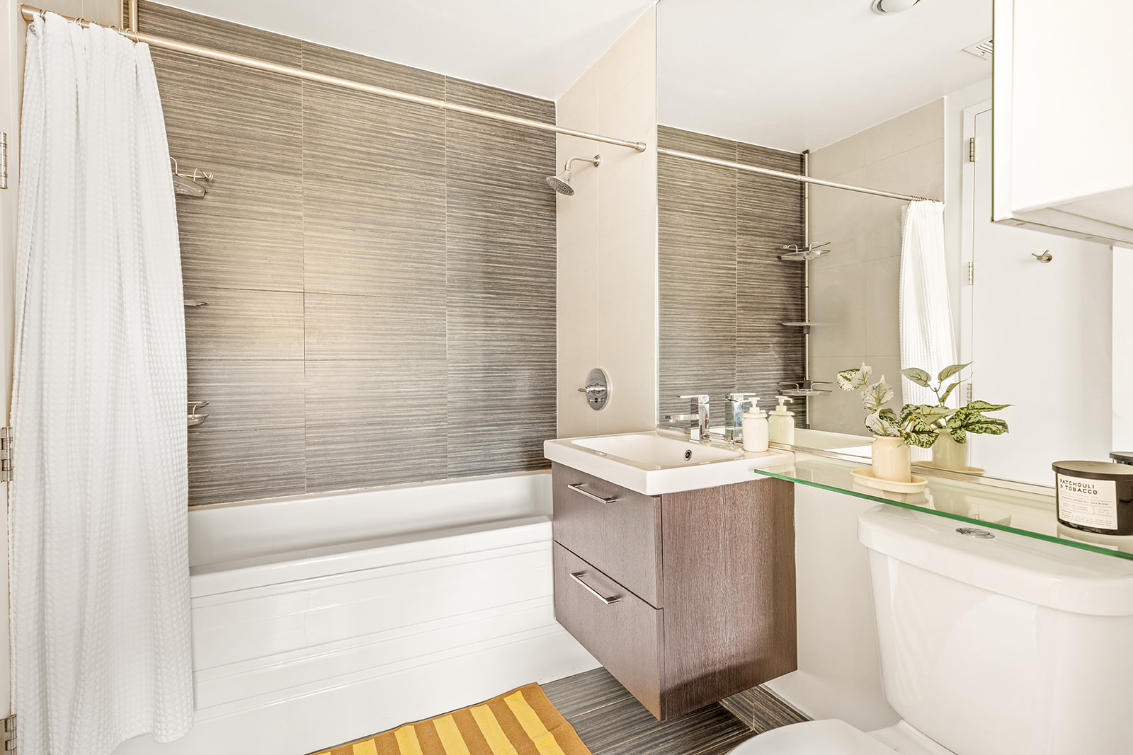 323 Greene Avenue, Unit 4A Brooklyn, NY 11238 - Photo 11 of 14 a bathroom with a sink double vanity mirror and a bathtub