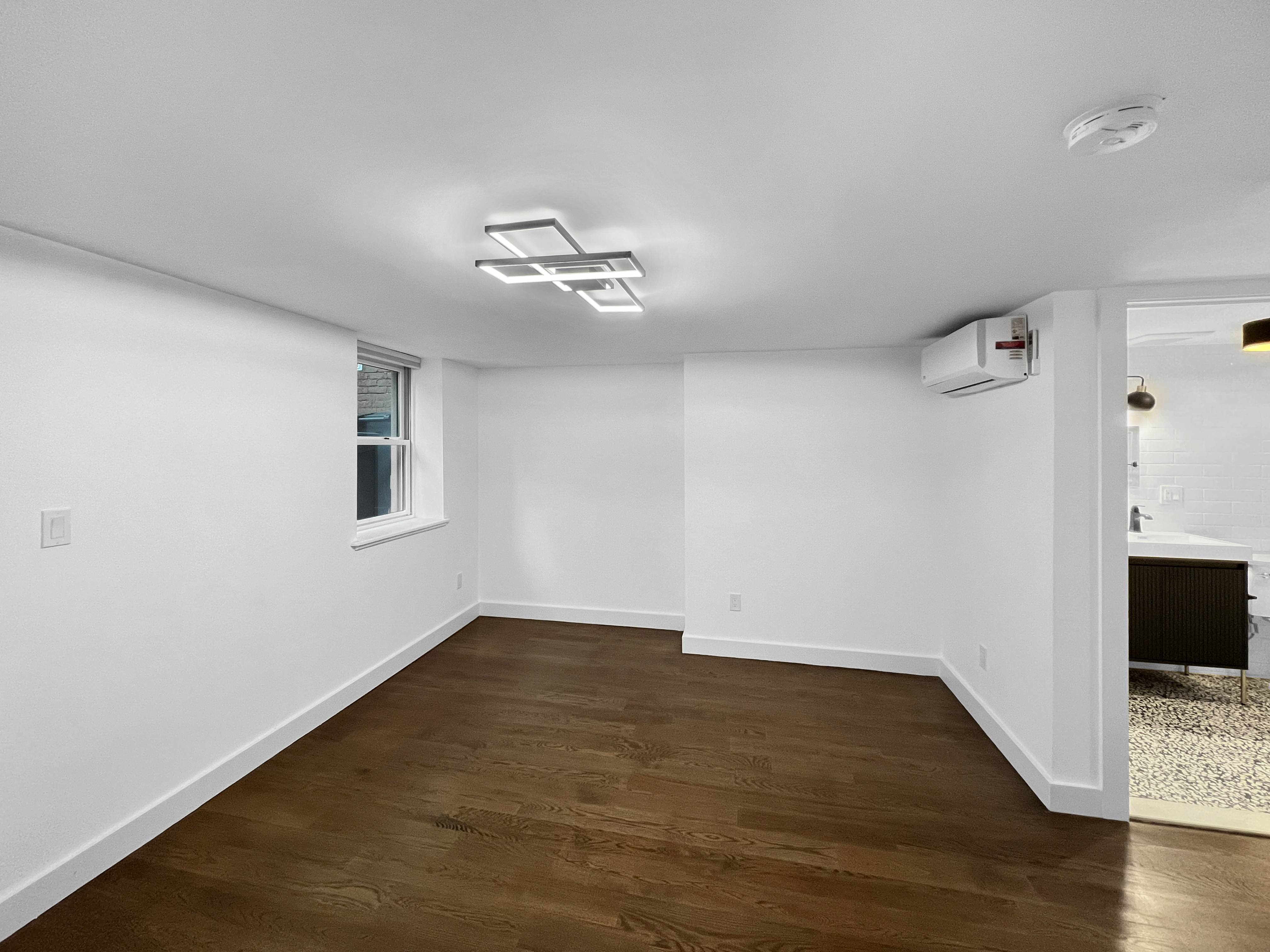 352 Degraw Street, Unit 1 Brooklyn, NY 11231 - Photo 9 of 20 a view of empty room with wooden floor and fan
