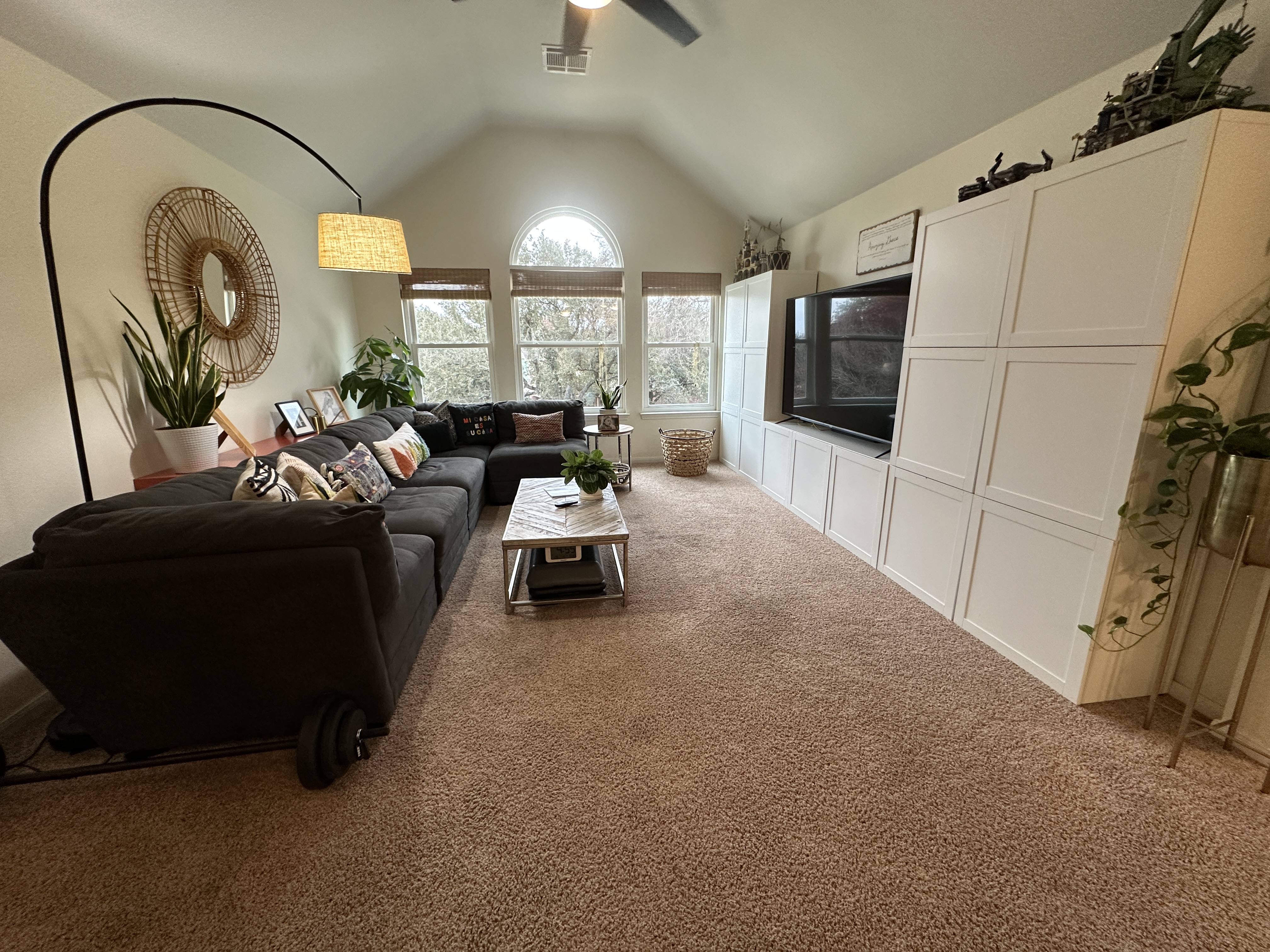 11105 Bexley Lane Austin, TX 78739 - Photo 10 of 12 a living room with furniture a flat screen tv and a floor to ceiling window