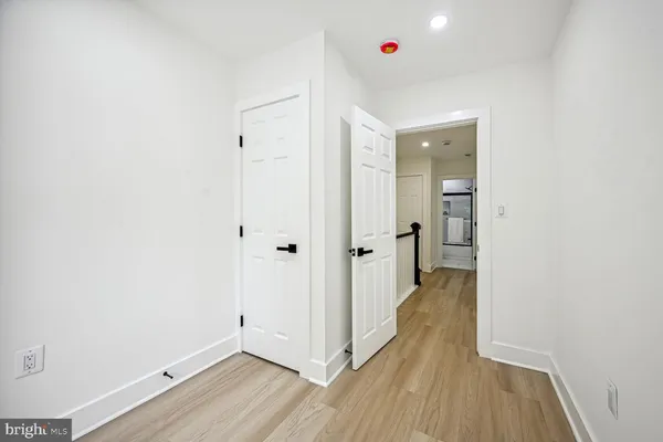 a view of a hallway with wooden floor