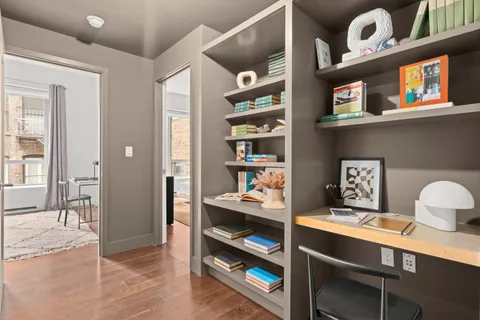 a view of a workspace with furniture and cabinet