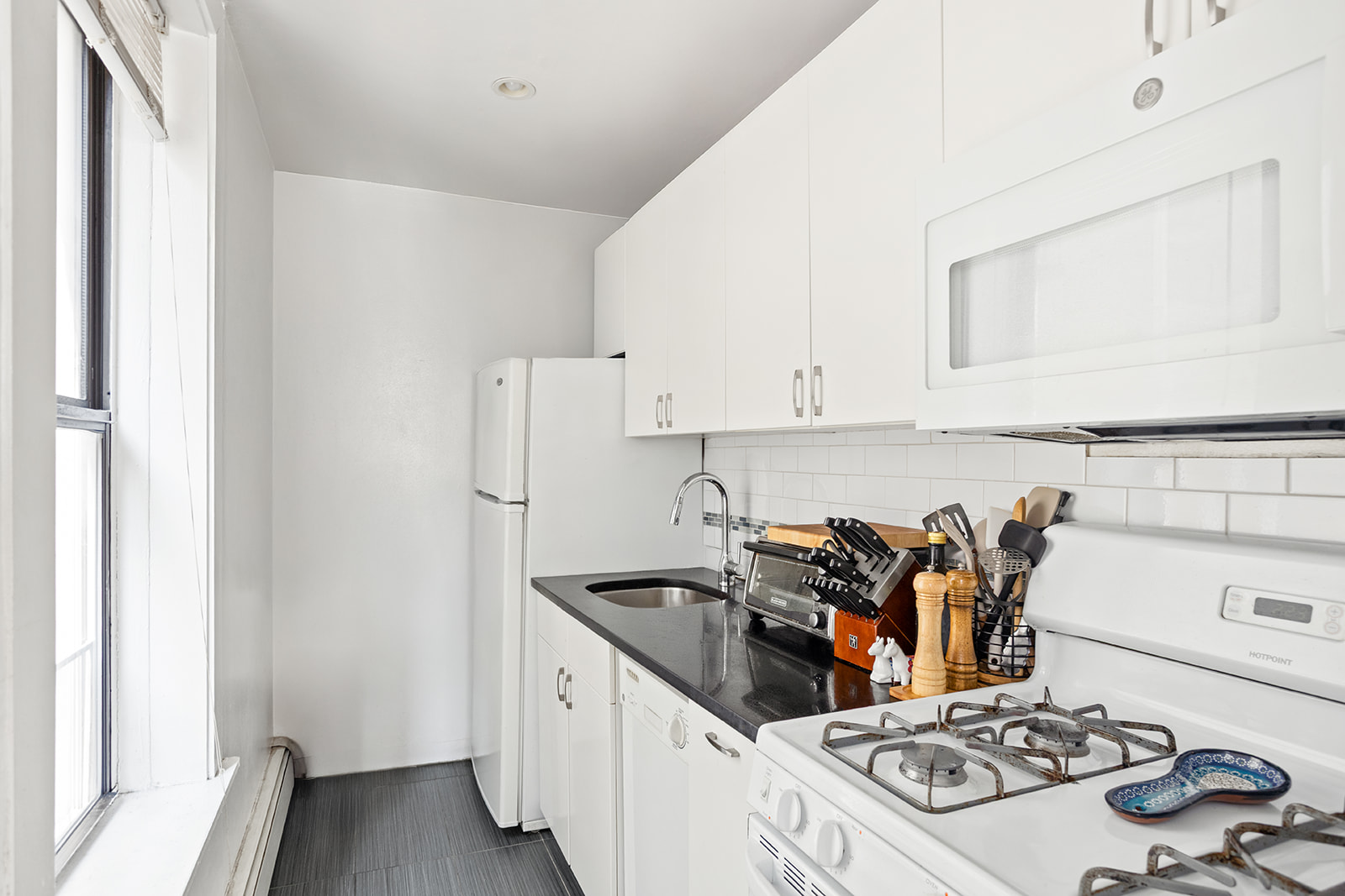 126 Sterling Place, Unit 2C Brooklyn, NY 11217 - Photo 4 of 8 a kitchen with stainless steel appliances a sink a stove and a refrigerator