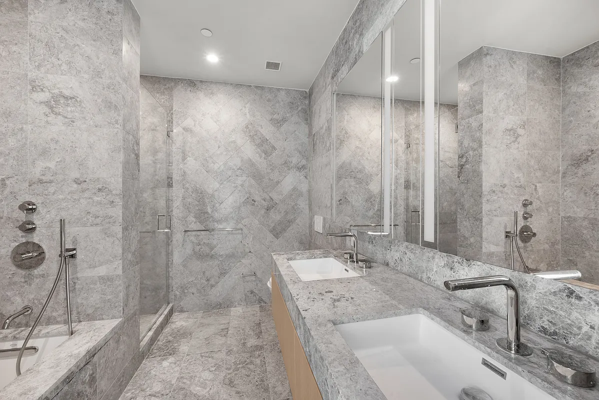 1059 3rd Avenue, Unit 10C Manhattan, NY 10065 - Photo 5 of 7 a bathroom with double vanity and a shower