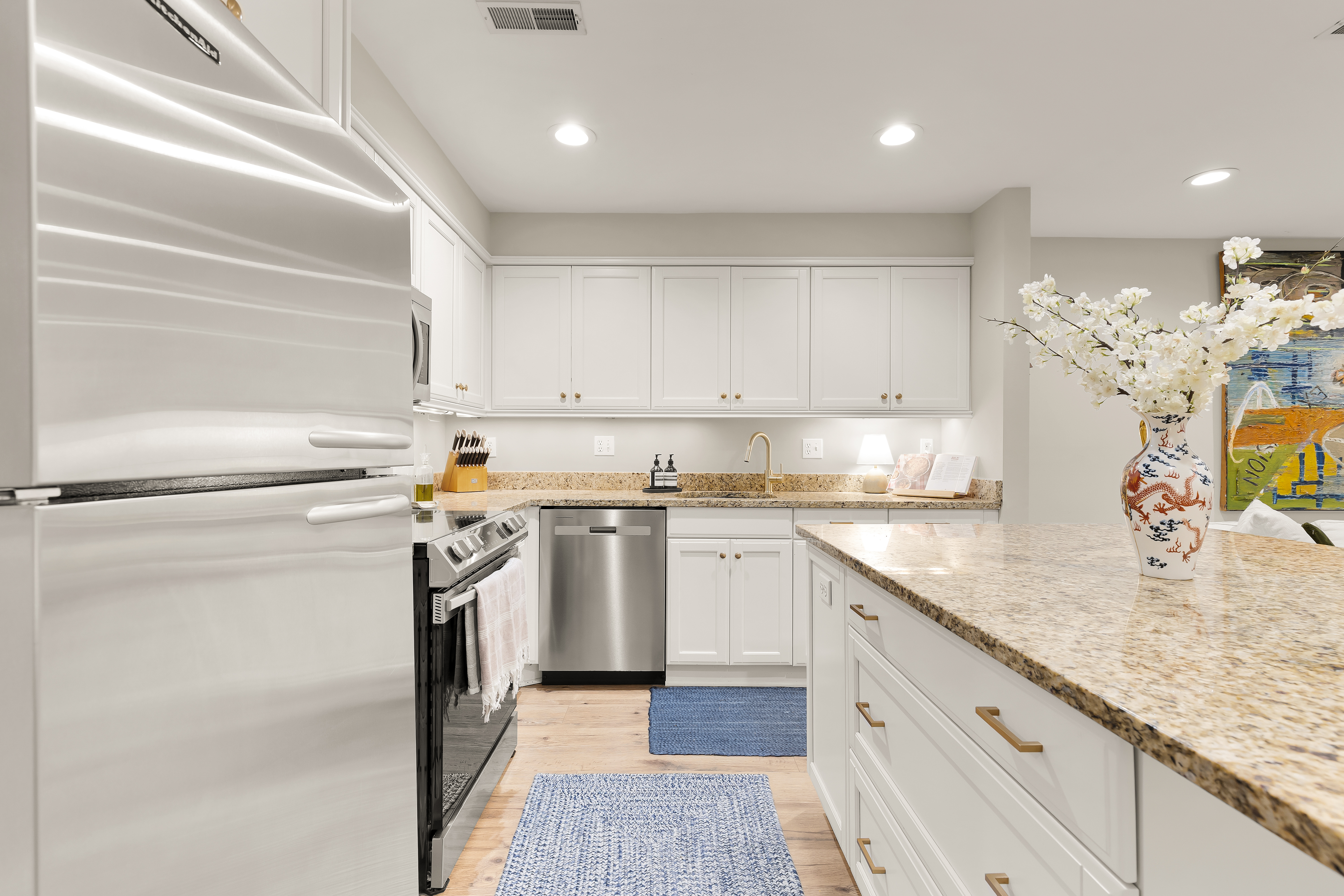 1354 Kenyon Street Northwest, Unit G Washington, DC 20010 - Photo 18 of 35 a kitchen with stainless steel appliances granite countertop a sink stove and refrigerator