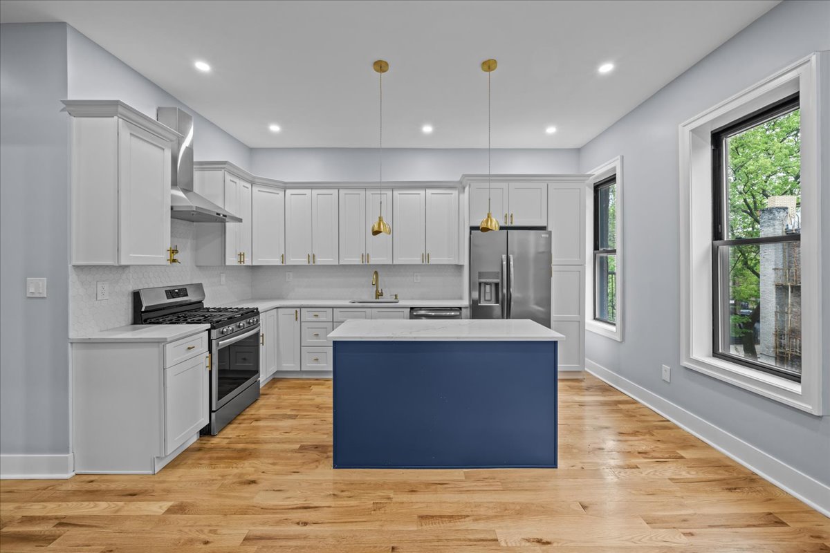 581 Decatur Street Brooklyn, NY 11233 - Photo 6 of 22 a large kitchen with stainless steel appliances granite countertop a stove a sink and a refrigerator
