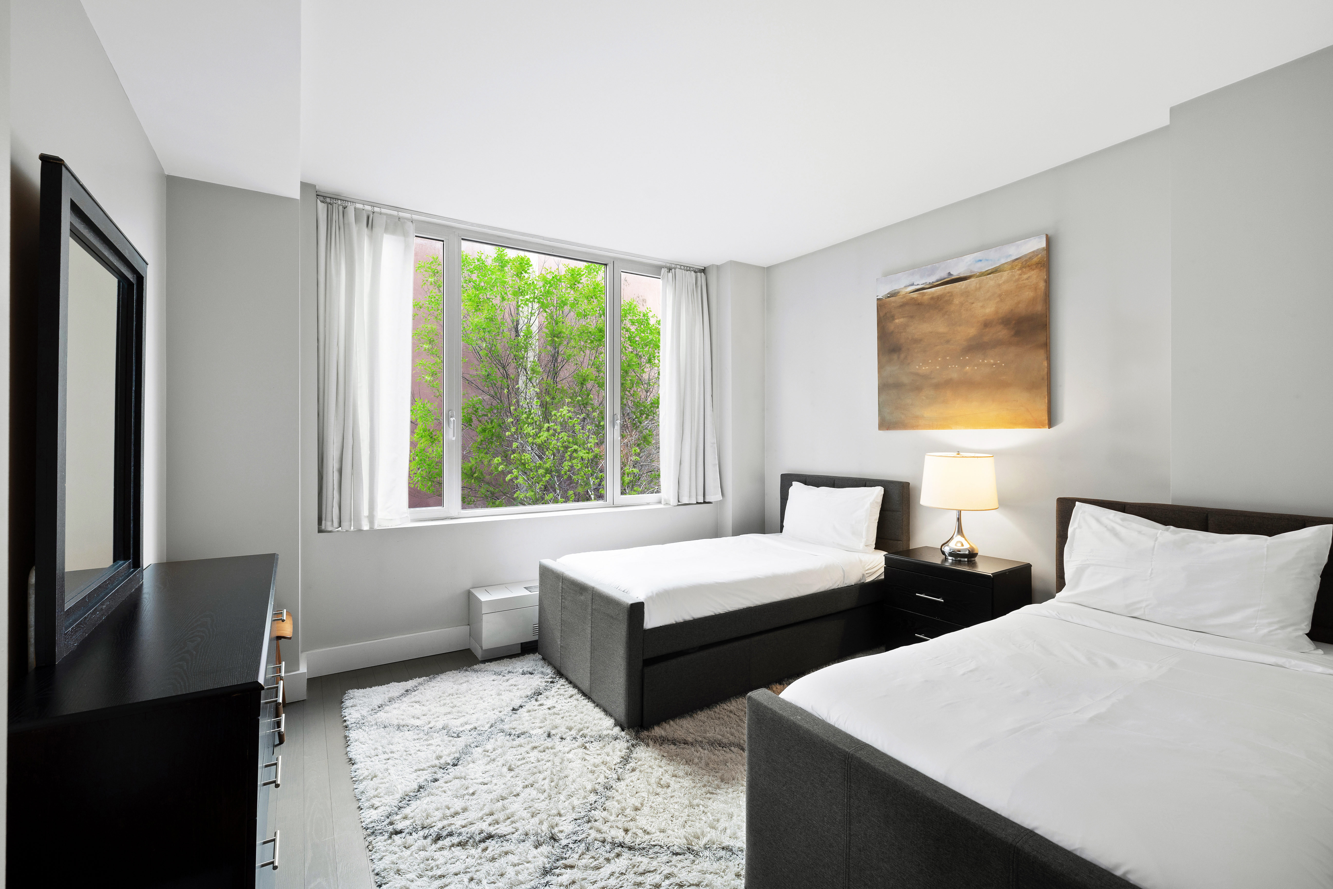 129 West 123rd Street, Unit 3 Manhattan, NY 10027 - Photo 10 of 20 a bedroom with two beds and a large window