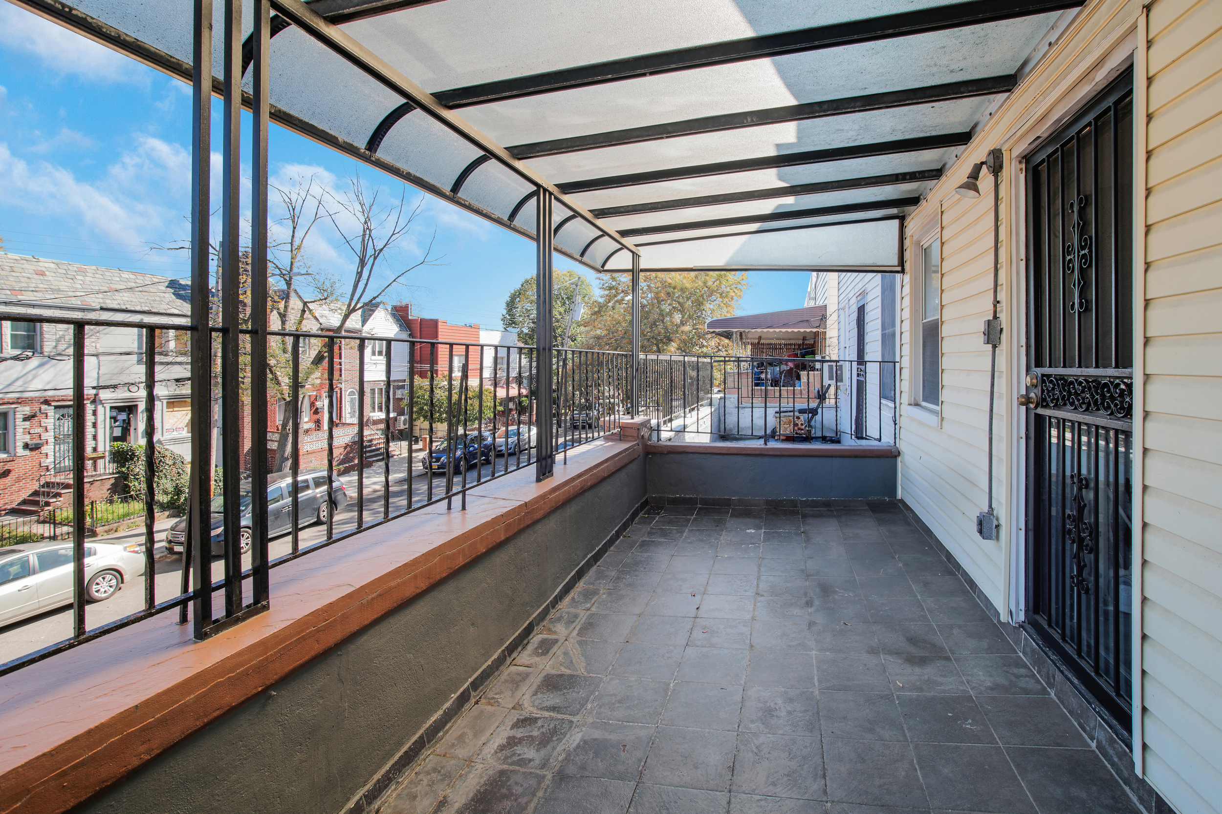 1532 Kimball Street Brooklyn, NY 11234 - Photo 11 of 13 a view of a porch with wooden floor and iron stairs