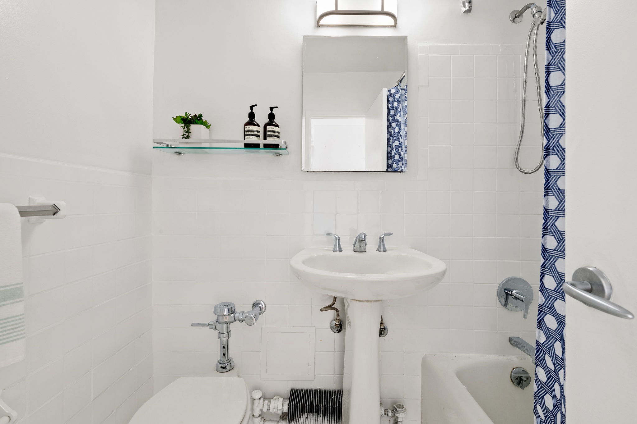 79 West 12th Street, Unit 6BC Manhattan, NY 10011 - Photo 8 of 15 a bathroom with a sink mirror and toilet