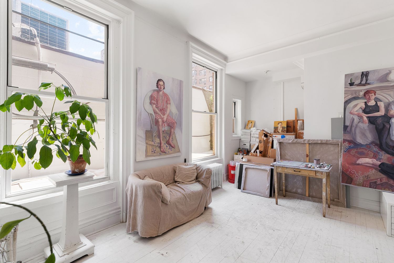 a living room with furniture and a potted plant